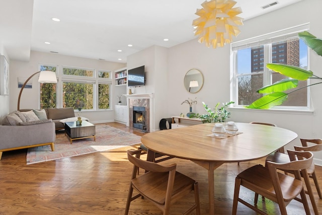 625 W Patterson Ave Unit 3E, Chicago, IL 60613 - dining space with a tile fireplace, wood finished floors, healthy amount of natural light, recessed lighting, and baseboards