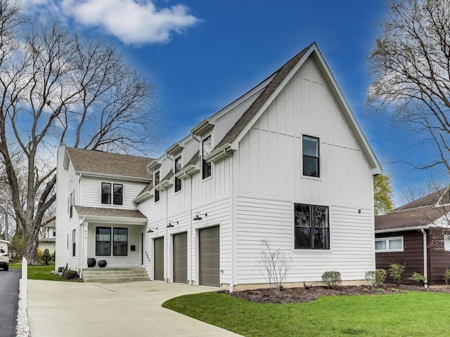 view of property exterior featuring concrete driveway, board and batten siding, an attached garage, a lawn, and roof with shingles