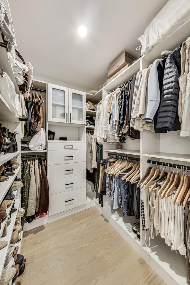 walk in closet featuring light wood finished floors