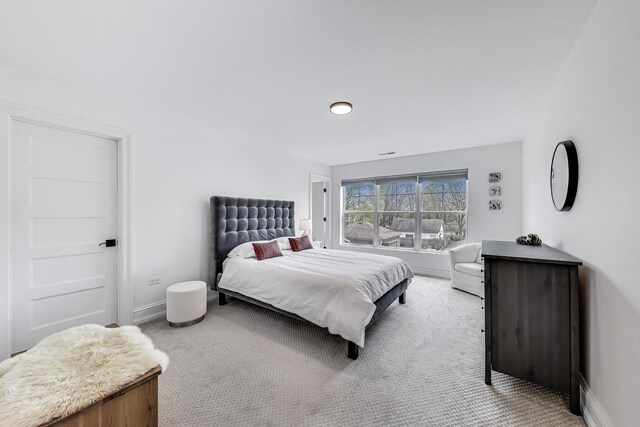 carpeted bedroom featuring baseboards