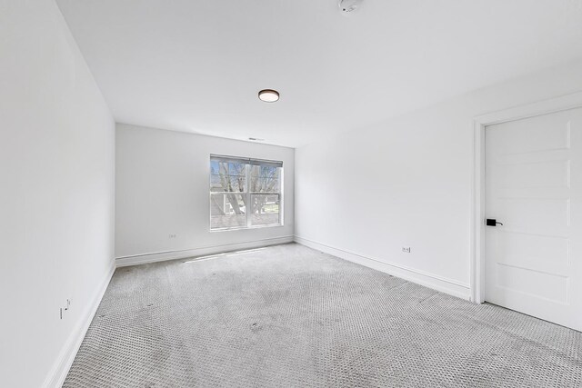 carpeted spare room with baseboards