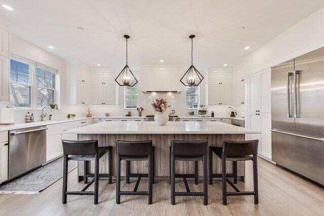 kitchen featuring a center island, white cabinetry, and stainless steel appliances
