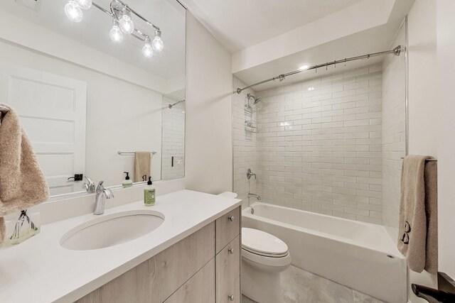 bathroom with bathtub / shower combination, vanity, and toilet
