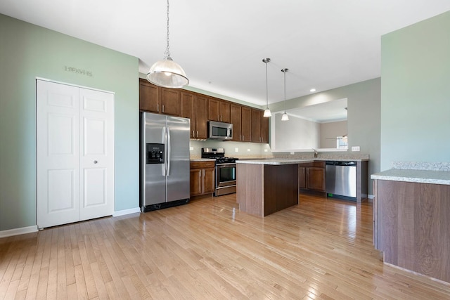 kitchen featuring stainless steel appliances, light wood-style floors, and light countertops