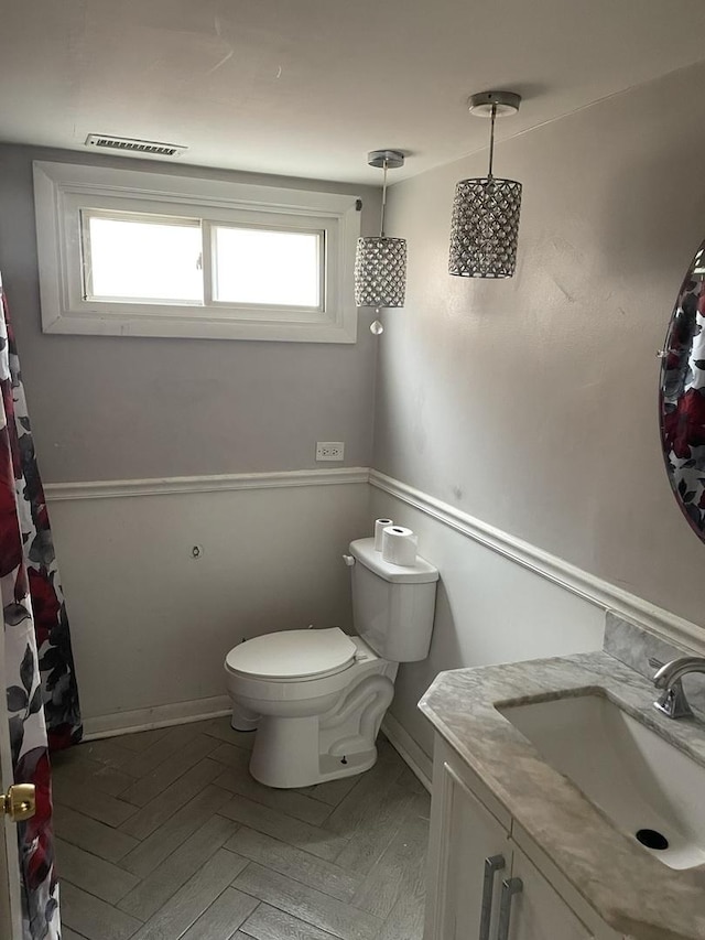 1641 Patricia Pl, Calumet City, IL 60409 - bathroom featuring toilet, baseboards, plenty of natural light, and vanity
