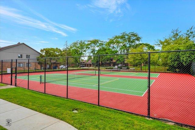 view of sport court featuring fence