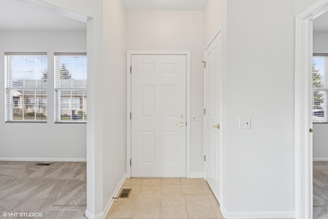 13425 Michigan Ave, Huntley, IL 60142 - entrance foyer featuring light carpet, light tile patterned floors, visible vents, and baseboards