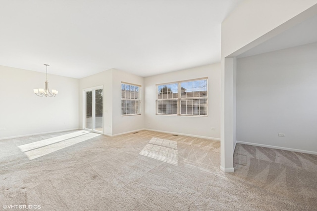 13425 Michigan Ave, Huntley, IL 60142 - unfurnished living room featuring baseboards, an inviting chandelier, and carpet floors