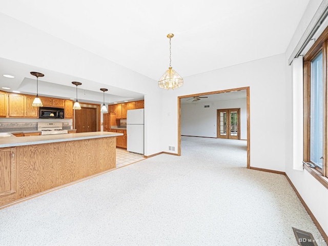 165 Fairfield Dr Unit 35B, New Lenox, IL 60451 - kitchen featuring white appliances, baseboards, a peninsula, light countertops, and decorative light fixtures