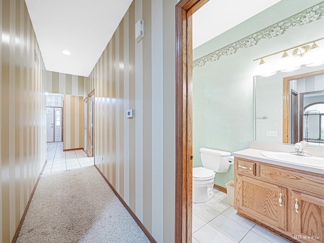 165 Fairfield Dr Unit 35B, New Lenox, IL 60451 - hallway with light tile patterned floors, wallpapered walls, a sink, and baseboards