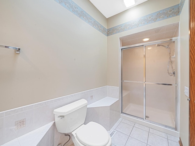 165 Fairfield Dr Unit 35B, New Lenox, IL 60451 - bathroom featuring tile patterned floors, a shower stall, and toilet