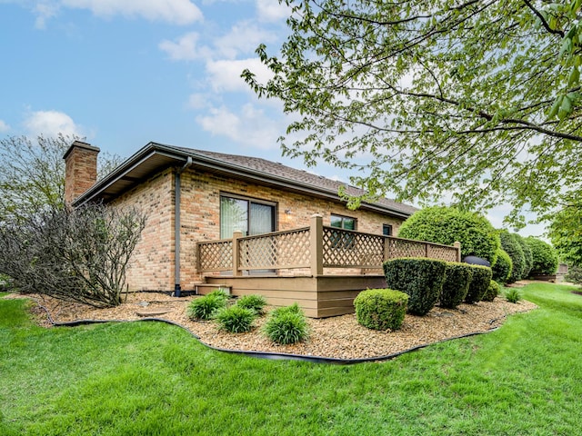 165 Fairfield Dr Unit 35B, New Lenox, IL 60451 - view of side of home with brick siding, a wooden deck, a chimney, and a yard