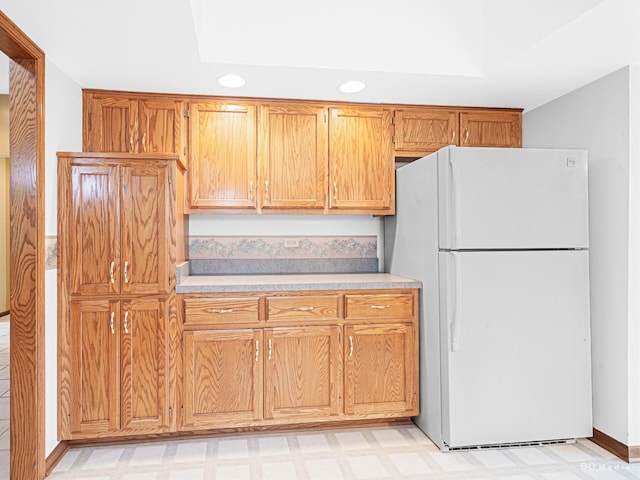 165 Fairfield Dr Unit 35B, New Lenox, IL 60451 - kitchen featuring freestanding refrigerator, light countertops, light flooring, recessed lighting, and brown cabinets