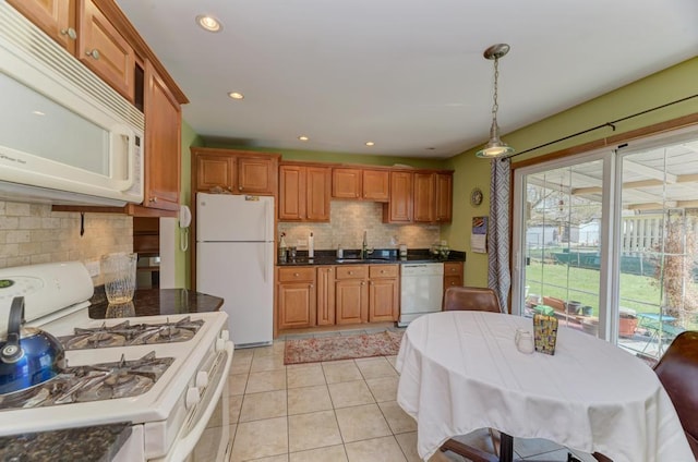 1735 W Woodland Ave, Addison, IL 60101 - kitchen with white appliances, a sink, dark countertops, brown cabinets, and backsplash