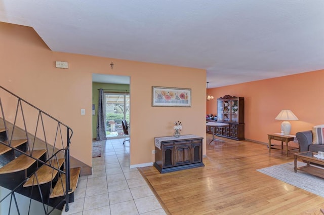 1735 W Woodland Ave, Addison, IL 60101 - living area with stairs, light wood-type flooring, and baseboards