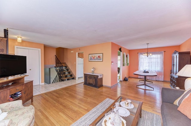 1735 W Woodland Ave, Addison, IL 60101 - living area with baseboards, an inviting chandelier, wood finished floors, and stairs