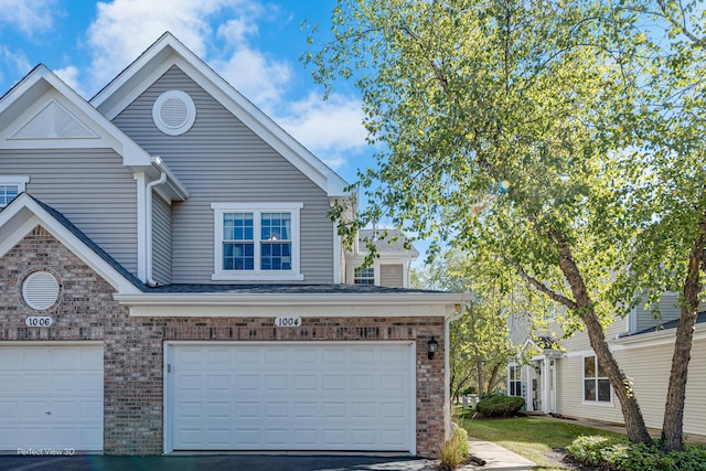 exterior space with brick siding and a garage