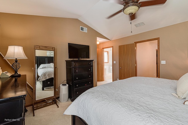 bedroom featuring lofted ceiling, visible vents, carpet floors, and connected bathroom