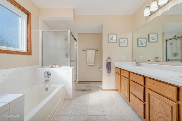 bathroom featuring a shower stall, tile patterned flooring, double vanity, a sink, and a bath