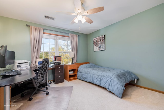 carpeted bedroom with visible vents, a ceiling fan, and baseboards