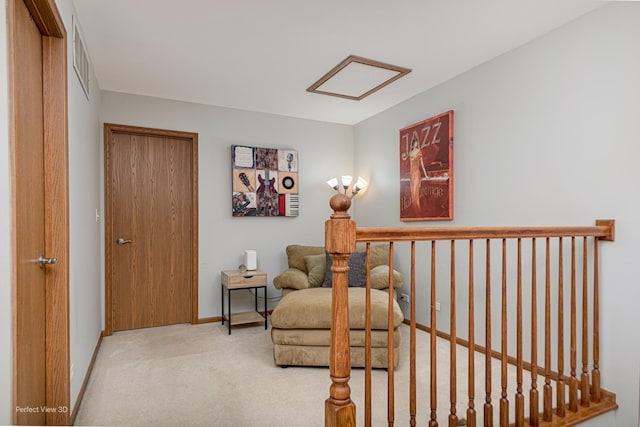 sitting room featuring carpet floors, visible vents, and baseboards