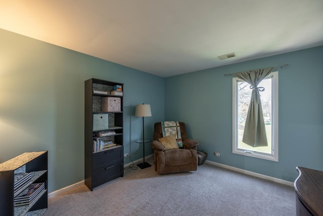 sitting room with baseboards, visible vents, and carpet