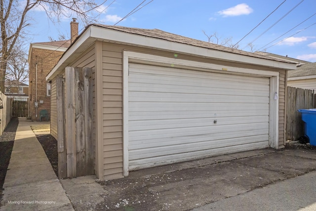 detached garage featuring fence