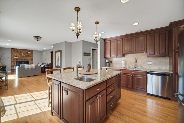 2005 Brentwood Ln, Wheaton, IL 60189 - kitchen with light wood finished floors, dishwasher, a brick fireplace, and a sink