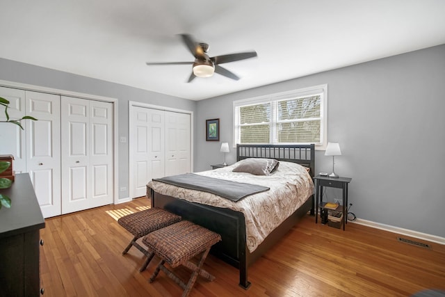 2005 Brentwood Ln, Wheaton, IL 60189 - bedroom with wood finished floors, multiple closets, baseboards, and visible vents