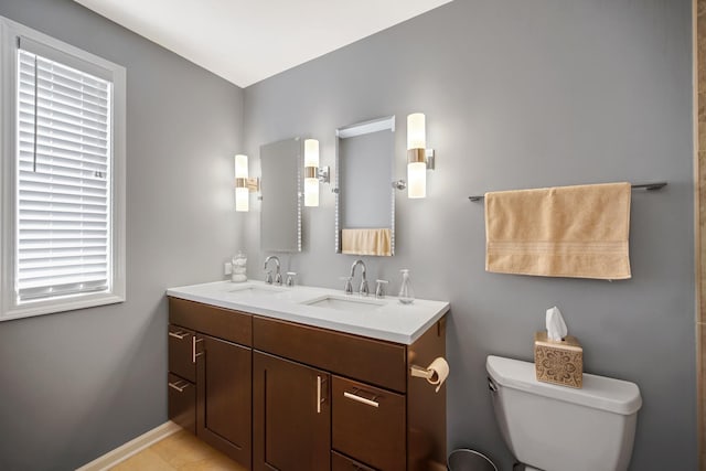 2005 Brentwood Ln, Wheaton, IL 60189 - bathroom with double vanity, toilet, baseboards, and a sink