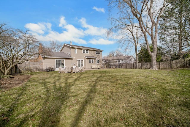 2005 Brentwood Ln, Wheaton, IL 60189 - rear view of property featuring a lawn, a fenced backyard, and a chimney