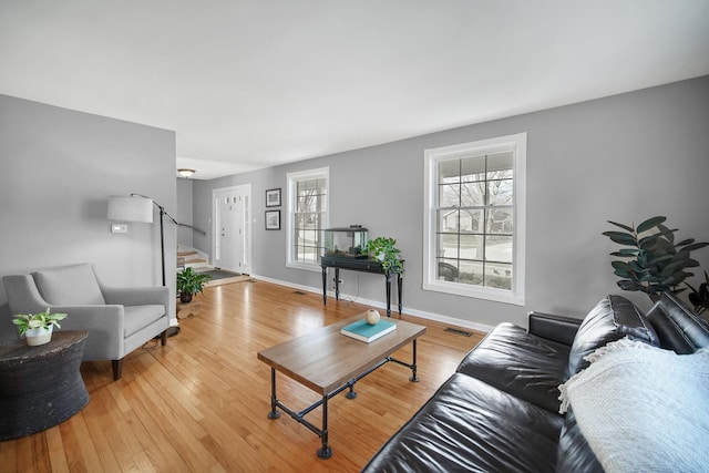 2005 Brentwood Ln, Wheaton, IL 60189 - living area with baseboards, stairs, visible vents, and light wood-style floors