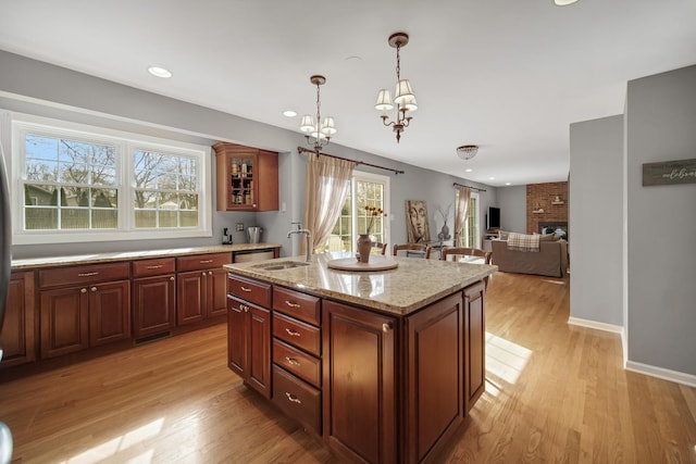 2005 Brentwood Ln, Wheaton, IL 60189 - kitchen with an inviting chandelier, hanging light fixtures, a sink, and light wood-style floors