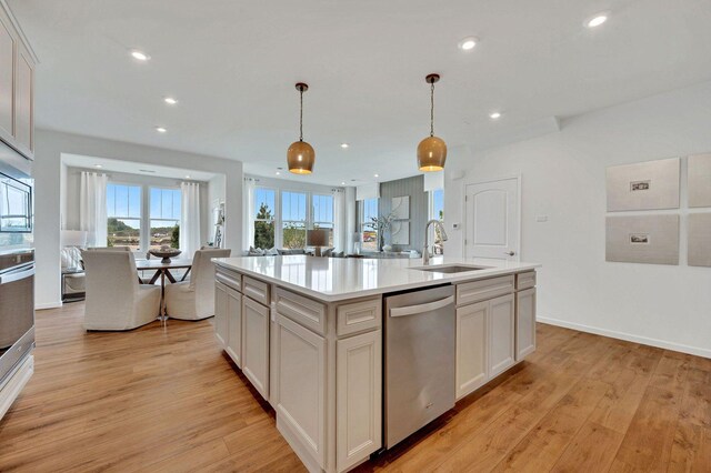24501 W Kroll Dr, Plainfield, IL 60585 - kitchen featuring light wood-style floors, light countertops, a sink, and appliances with stainless steel finishes