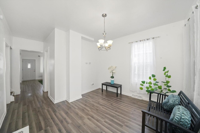 sitting room featuring dark wood-type flooring, a chandelier, visible vents, and plenty of natural light
