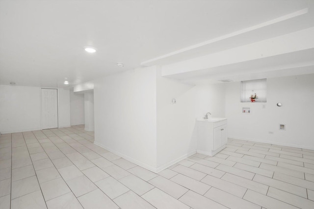 interior space featuring a sink, light tile patterned floors, baseboards, and recessed lighting