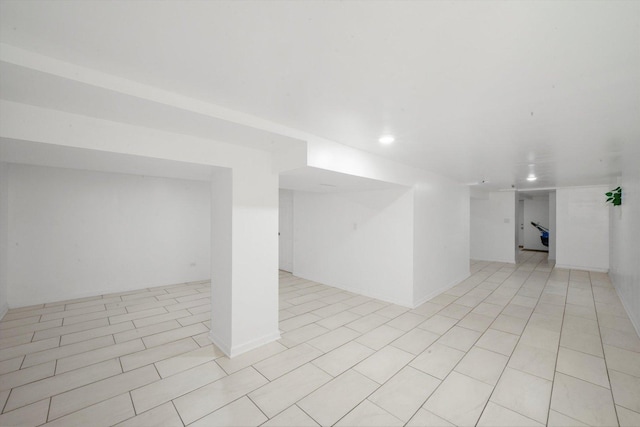 finished below grade area featuring light tile patterned floors and recessed lighting