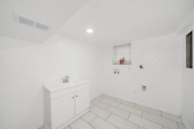 laundry room featuring baseboards, visible vents, laundry area, hookup for a washing machine, and a sink