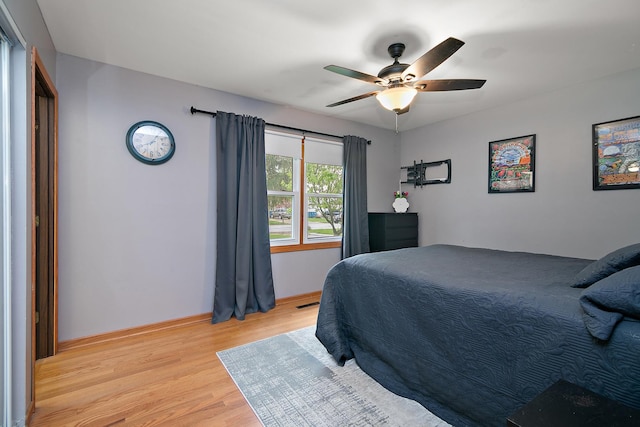 bedroom with ceiling fan, light wood-style flooring, and visible vents
