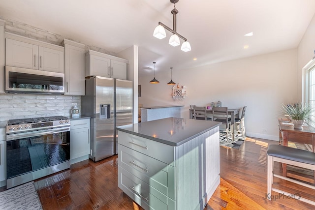 117 Rachel Ave, Willow Springs, IL 60480 - kitchen with dark countertops, dark wood-style floors, appliances with stainless steel finishes, and tasteful backsplash