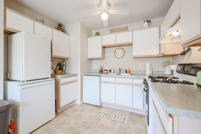 kitchen featuring a sink, freestanding refrigerator, under cabinet range hood, dishwashing machine, and range with gas stovetop