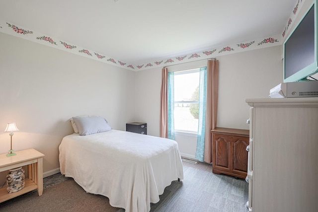 bedroom featuring baseboards and light colored carpet