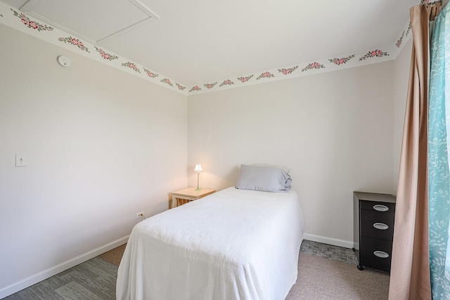 carpeted bedroom featuring baseboards
