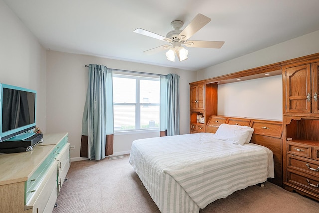 bedroom featuring light carpet, baseboards, and a ceiling fan