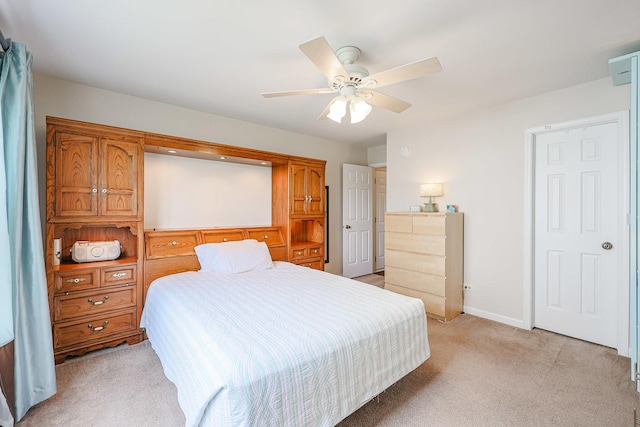 bedroom with light carpet, ceiling fan, and baseboards
