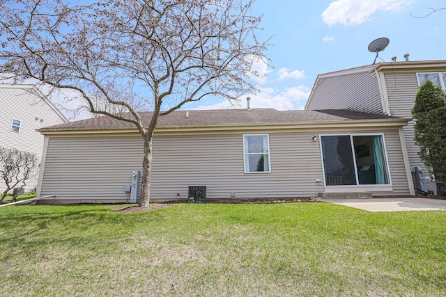 back of house with a patio area and a lawn