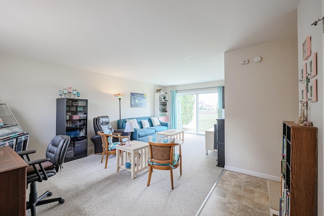 home office with light carpet, baseboards, and stone finish flooring