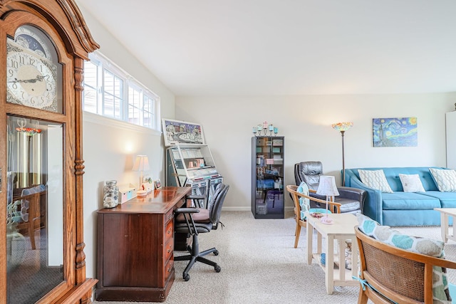 office space with baseboards and light colored carpet