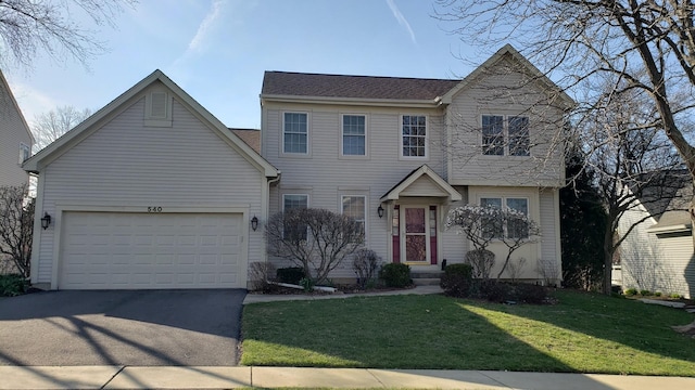 view of front of home with an attached garage, aphalt driveway, and a front yard