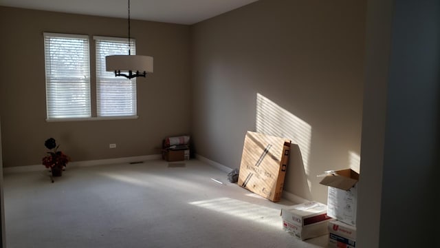 interior space with carpet, baseboards, and a wealth of natural light